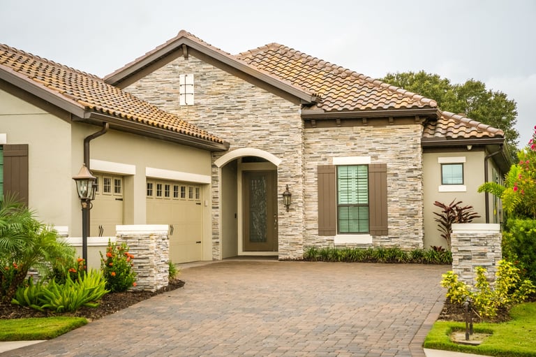 Wet look sealed paver driveway with glossy rich finish on a Florida home