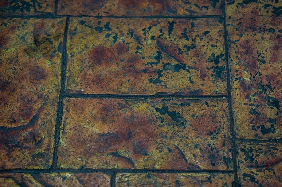 Orange rust staining from well water irrigation on paver driveway in Marion Oaks Ocala FL